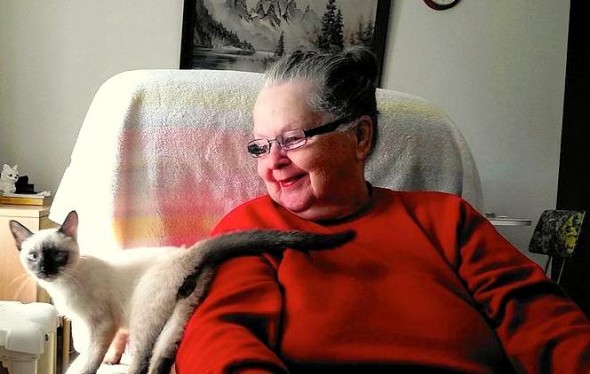 Mary St. Clair and her cat Thai are helped by the Animeals program.