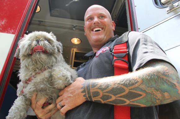 Flagler County paramedic Ivan Grant and Muffy. Photo Credit: Shanna Fortier