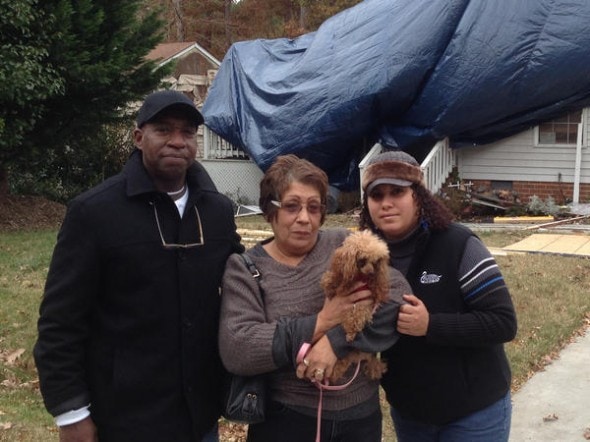 Talita Swann, Edward Swann (husband) and Krista Griffin (daughter) pose with Angelina, the dog who survived trapped in house fire for 40 minutes. Photo Credit:  Susan Robertson /The Virginia Gazette