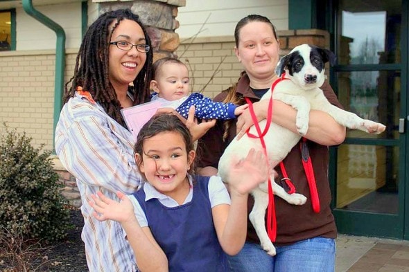 Snorkle, held by adoption councelor Nina, prepares to begin a life with his exuberant new family.