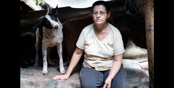 Maria del Carmen Quiceno poses with one of her 63 rescue dogs. Photo Credit: Javier Nieto/El Tiempo