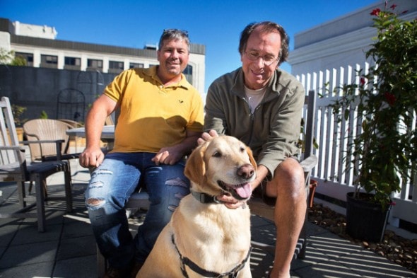 Dog rescuer Greg Mahle and journalist/author Peter Zheulin with his dog Albie at the WBUR studios. (Jesse Costa/WBUR)