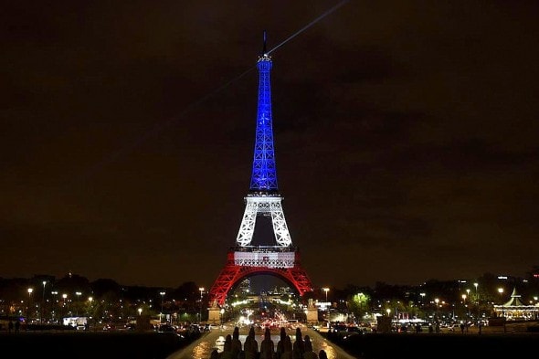A photo taken on November 16, 2015 in Paris shows the Eiffel Tower illuminated with the colors of the French flag in tribute to the victims of the November 13, 2015 Paris terror attacks. AFP PHOTO / ALAIN JOCARD (Photo credit should read ALAIN JOCARD/AFP/Getty Images)