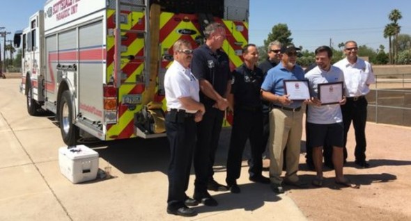 Danny Ortega and Tyler Moore hold certificates from the Scottsdale Fire Department . (Photo: Lucas Robbins/The Republic) ----------------------------------